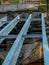 Renovation of a small old bridge. Steel girders painted and in good condition lying on rotten and rotten wooden sleepers