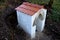 Renovation of a well with repair of a roof made of burnt tiles. a small brick building with a goric appearance. digging the soil a