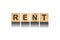 Rent, inscription from the alphabet on wooden cubes on a white background.