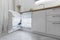 Rent of modern housing sale of new apartment, modern renovation. White furniture with utensils, shelves with crockery and plants