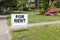 FOR RENT sign posted in lawn