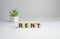 Rent word on wooden cubes, white background