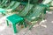 Rental beach canvas chairs and green table on natural white sand