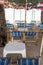 Rental blue beach canvas chairs and white table under colorful u
