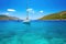 rental catamarans floating in clear, turquoise sea