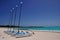 Rental Catamarans parked on a white beach.