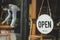 Reopen. coffee cafe shop text on vintage sign board hanging on glass door in modern cafe shop open after coronavirus quarantine is