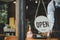 Reopen. friendly waitress woman staff wearing protection face mask turning Open sign board reopen after coronavirus quarantine is