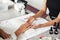 Reopening of beauty salon and a lot of work. Manicurist checks nails african american woman on table with equipment and