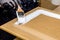 Repainting kitchen cabinet doors with white chalk paint indoors at home.