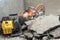 repair of asphalt concrete pavements. Pieces of old asphalt. Road repairs. A tool for cutting rebar and concrete in the back of a