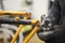 Repair of a bicycle: person disassembling an orange bike in his workshop