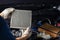 Repair and check car air conditioning system Technician holds car air filter to check cleanliness Clogging dirty or replacing the