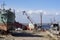 Repair of commercial fishing longboats on the pier