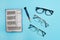 Repair of glasses. On a blue background, a group of glasses and a screwdriver. Eyewear repair tools and accessories.