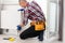 Repair heating radiator close-up. man repairing radiator with wrench. Removing air from the radiator.