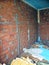 Repair in the home. Wall with a layer of plasterboard removed, a brick with stucco