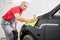 Repair man worker polishing automobile car body in garage