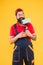 Repair paintng tool. cheerful bearded man worker with roller tool. hipster artist decorator yellow wall. erector