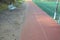 Repair of a public playground with artificial grass and a running track in the park. . The patches have a different carpet color a