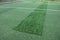 Repair of a public playground with artificial grass and a running track in the park. . The patches have a different carpet color a