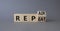 Repair and Repeat symbol. Turned wooden cubes with words Repeat and Repair. Beautiful grey background. Business and Repair and