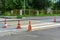 The repair of the road, orange cones around the pedestrian crossing