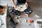 Repair of a robot vacuum cleaner that is clogged with dirt and wool. A male repairman holds a disassembled robot vacuum cleaner.