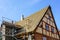 Repair of the roof structures of a historic wooden house and replacement of clay tiles