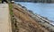 Repair of the slope above the river, the river banks are strengthened by a bunch of stonemasons where the embankment is paved with