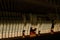 Repair of a stringed musical instrument. Inside view of a piano with brass metal strings and a wooden mallet. A musical