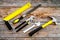 Repair tool kit. File, hummer, corner ruler on rustic wooden background top view pattern