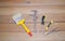 Repair tools: a wide brush, a caliper, screwdrivers and tweezers on a wooden background