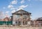 Repair of the two-storeyed wooden house, rural landscape