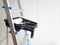 Repair of the wall . Stepladder, roller and brush in a black tray on a white background