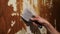 Repair the walls in the apartment with a spatula remove old wallpaper