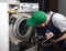 Repair of washing machines. A technician examines an old broken washing machine and records