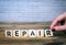 Repair. Wooden letters on the office desk