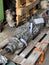 Repaired engine gearboxes lie on wooden pallets in the shed