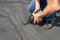 Repairing cracks in driveway with asphalt crack filler