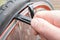 Repairing a punctured bicycle wheel. Cyclists hand removes the tire with a special lever tool.