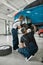 Repairing your vehicle. Full length shot of two male mechanics using torch for examining car wheel brake disc of lifted