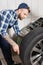 Repairman examining wheel on balance control