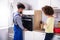 Repairman Fixing Oven In Kitchen