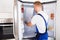 Repairman Fixing Refrigerator