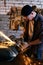 Repairman grinding motorbike fuel tank in his workshop medium