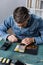 Repairman with holding sensors of multimeter