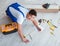 Repairman laying laminate flooring at home