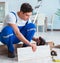 Repairman laying laminate flooring at home