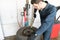 Repairman Removing Tire From Rim On Machine At Garage